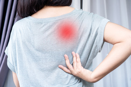 Woman suffering from Scapulocostal Syndrome Back and Shoulder Muscle Painの写真素材
