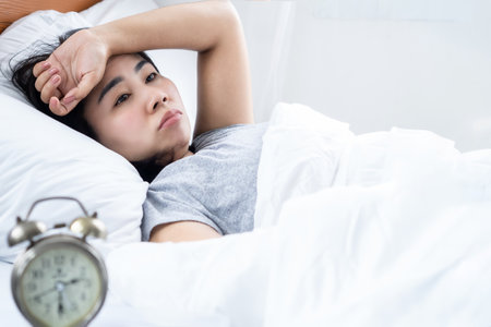 Asian woman with mental health problem over thinking, sleeping problem conceptの写真素材