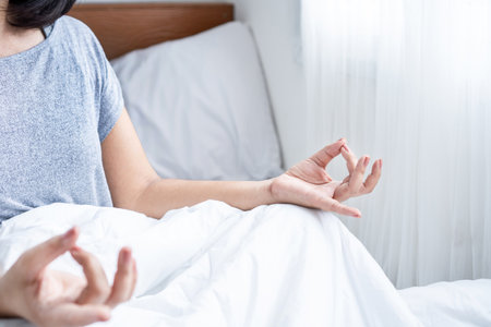 close up woman hand do meditating in bed, morning yoga, self care conceptの写真素材