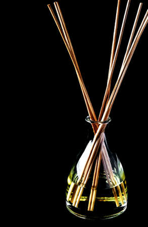 Aroma  oil and beautiful treatment-sticks diffuse on the blackの写真素材