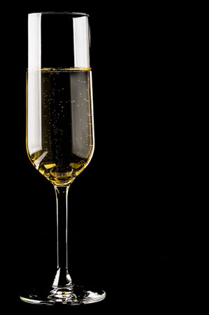 Champagne in a glass on a black backgroundの写真素材