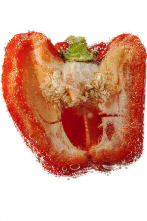 Pepper in water with bubbles on a white background 