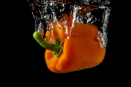 Paprika in water on a black background の写真素材