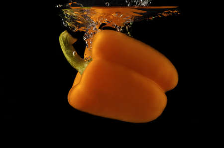 Paprika in water on a black background の写真素材