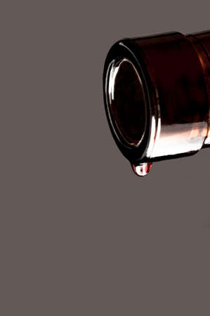 Wine drop and bottle on a gray backgroundの写真素材