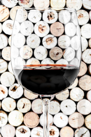 Wine glass on corks backgroundの写真素材