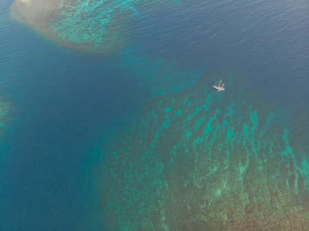 Sailboat On Caribbean Coral Reefの写真素材