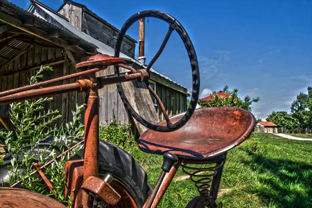 an old farm tractor on an abandon farm