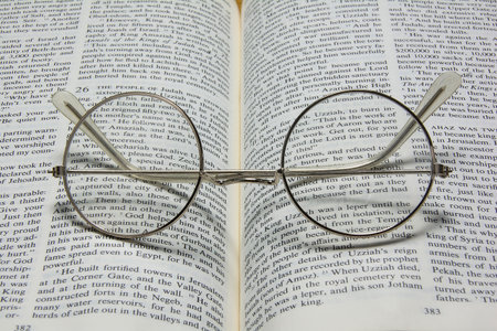 a open book with a old pair of glassesの写真素材