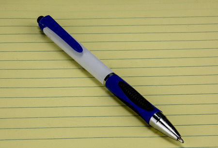 ink pen on yellow lined paperの写真素材