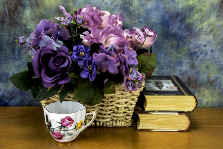 assorted flowers with an tea cup and books,の写真素材