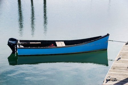 a small boat tied to a pierの写真素材