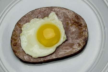 slice of ham with an egg on topの写真素材