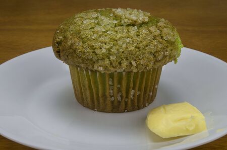 pistachio muffin with slice of butterの写真素材