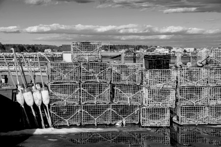 lobster traps and buoys lined the pier in new england.の写真素材