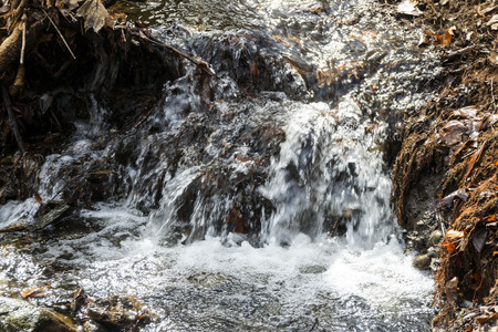 water cascading over rocks in a small brook.の写真素材