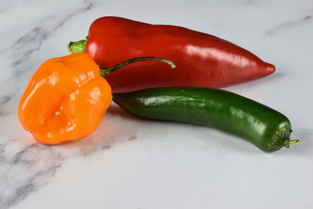 hot peppers on a white back groundの写真素材