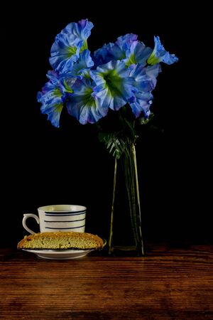 biscotti with a cup of tea and flowers,の写真素材