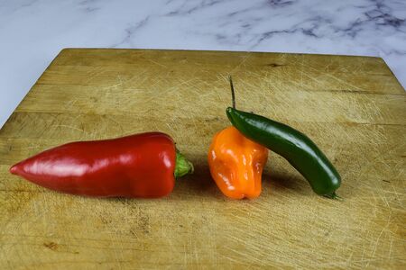 three pepperson a chop boardの写真素材