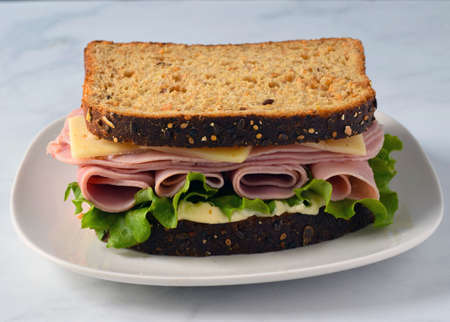 ham with lrttuce top with  swiss cheese on wheat breadの写真素材