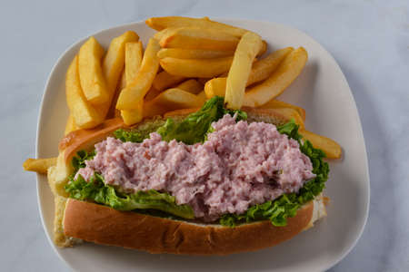 ham salad roll served with a side of friesの写真素材