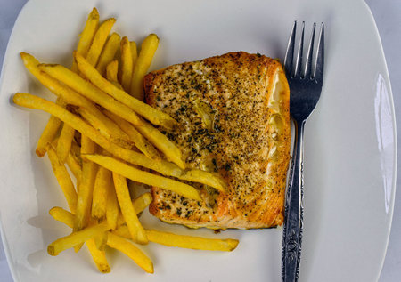 baked salmon  top with pepper with a side of fries