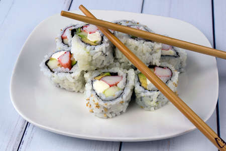 california cheese roll arranged on a plate with chop sticks,の写真素材