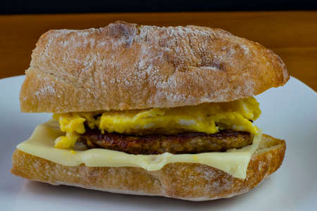 scrambled egg on a sausage patty between ciabatta bread with cheeseの写真素材