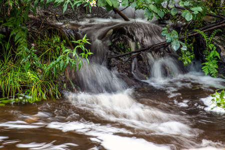 water cascading over a rock in willard brook locrted at willard brook state forest in townsendの写真素材