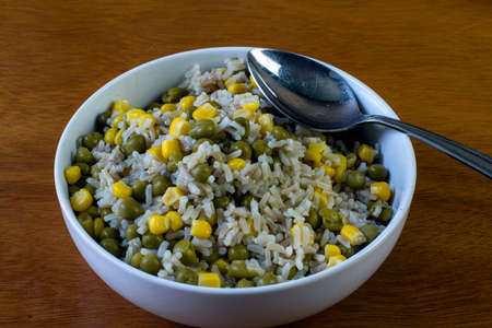 bowl of rice mixed with corn and peasの写真素材