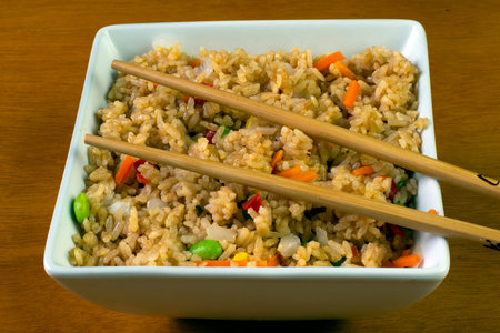 bowl of fresh  vegetable fried rice  with chop sticks,の写真素材