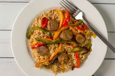 brown rice top with onions peppers and onionsの写真素材