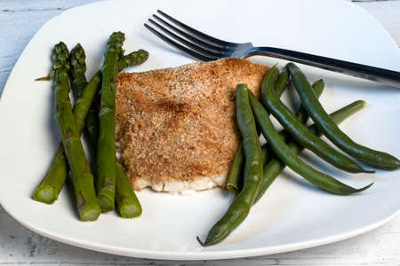 baked haddock served with asparagus and green beansの写真素材