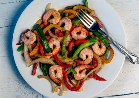 sauteed shrimp served with sauteed onons and peppers,の写真素材