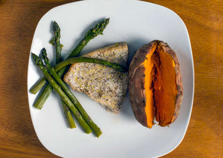 season tuna steak served with asparagus and sweet potato.の写真素材