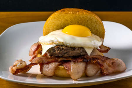 hamburgerbreakfast sandwich with bacon  and top with fried eggの写真素材