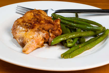 baked chiken thigh served with sauteed green beens,の写真素材