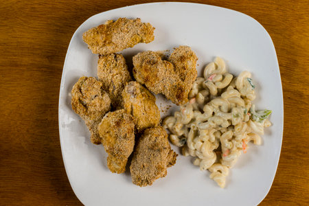 baked chicken wings served with macaroni salad,の写真素材
