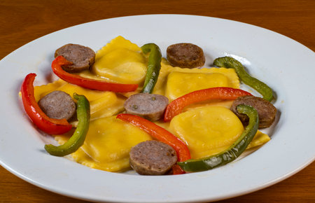 four cheese ravioli served with sauteed peppers and  iotalian sausageの写真素材