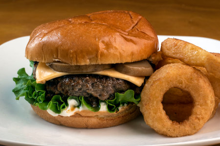 mushroom cheese burger  served with a side of onion rings,の写真素材