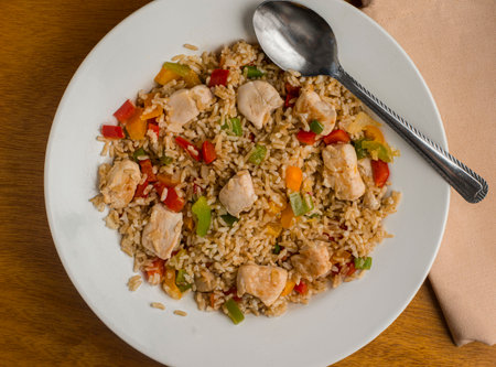 brown rice  served with sauteed pepper and chickenの写真素材