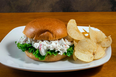 seafood salad on a brioche bun  and served with potato chipsの写真素材