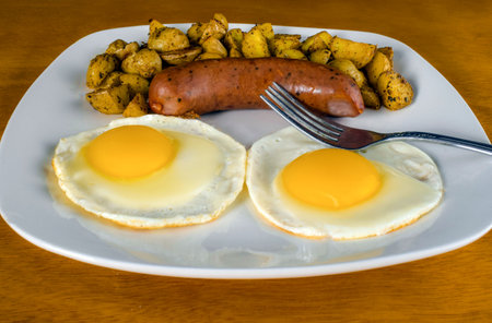 two eggs with kielbasa  served with home fries on the sideの写真素材
