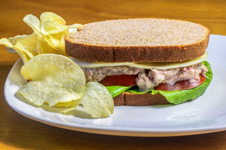 tuna salad sandwich  served with  aside of potato chipsの写真素材