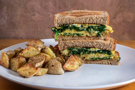 scramble egg and spinch  sandwich served with  home fries,の写真素材