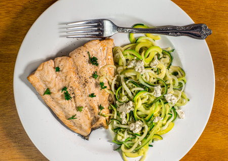 baked  salmon with seasoning  serrved with zucchini noodles  top with  goat cheeseの写真素材