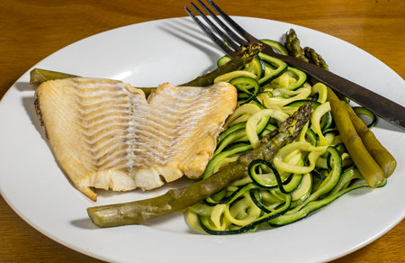 baked haddock, served with zucchini noodle and asparagusの写真素材