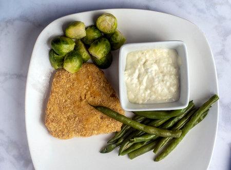 plant based fish fillet served with green beans and brussel  sproutsの写真素材
