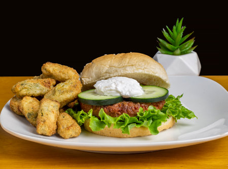 plant based burger top with cucumber and cottage cheese  served with broccoli tots,の写真素材