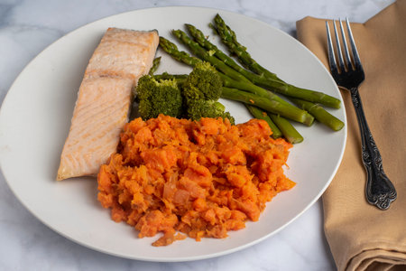baked salmon  served with asparagus , broccoli and mashed carrotsの写真素材